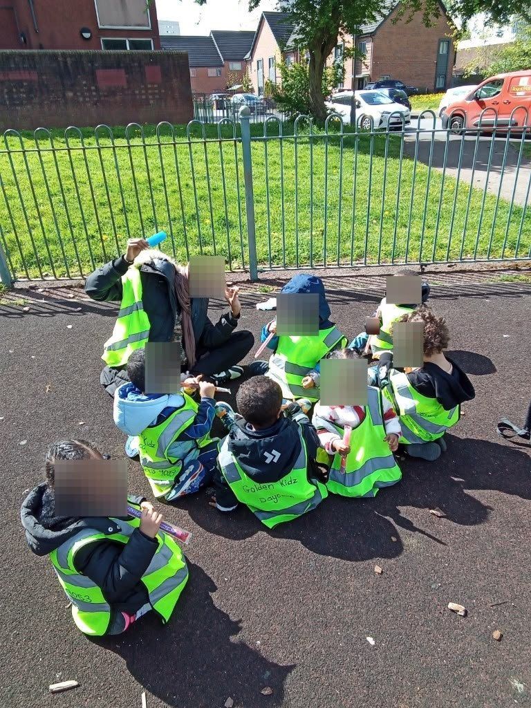 Children in high-vis vests enjoying our outdoor play sessions